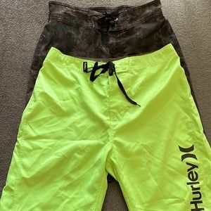 Two pair swim trunks, youth size 12. Under Armour and Hurley.